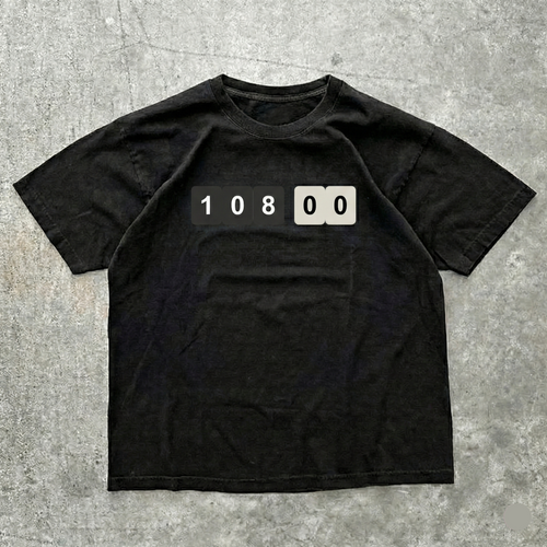 Black t-shirt with a numeric design on a gray concrete surface